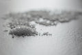 Coarse Salt - Detailed shot of coarse rock salt scattered on a textured surface.