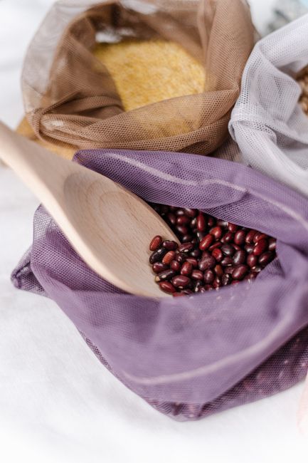 Azuki Beans - Red adzuki beans in a reusable net bag with a wooden scoop, promoting zero waste lifestyle.